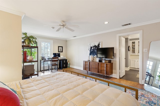 bedroom with connected bathroom, ornamental molding, hardwood / wood-style flooring, and ceiling fan