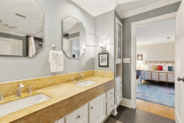 bathroom with ornamental molding, tile patterned floors, and vanity