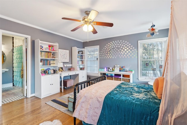 bedroom featuring light wood-type flooring, ceiling fan, and crown molding