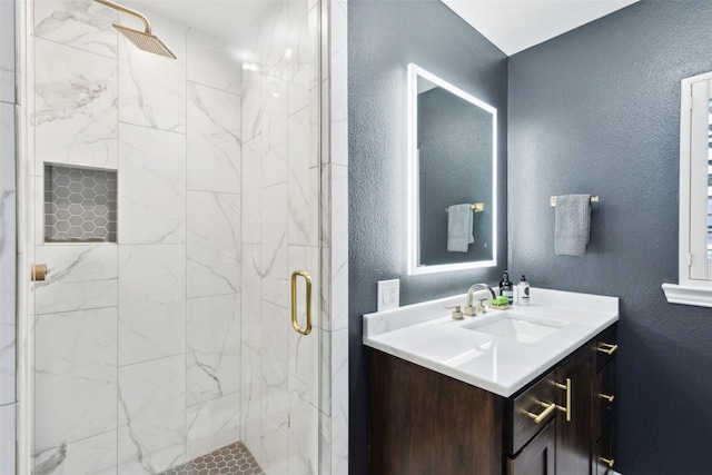 bathroom featuring vanity and a shower with shower door