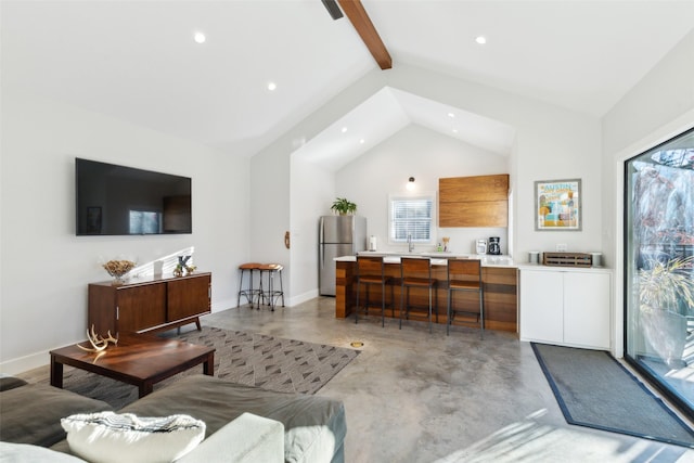 living room with high vaulted ceiling and beamed ceiling