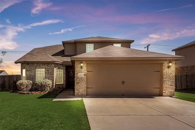 view of front of property with a lawn and a garage