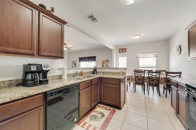 kitchen featuring black dishwasher, kitchen peninsula, ceiling fan, light stone counters, and light tile patterned floors