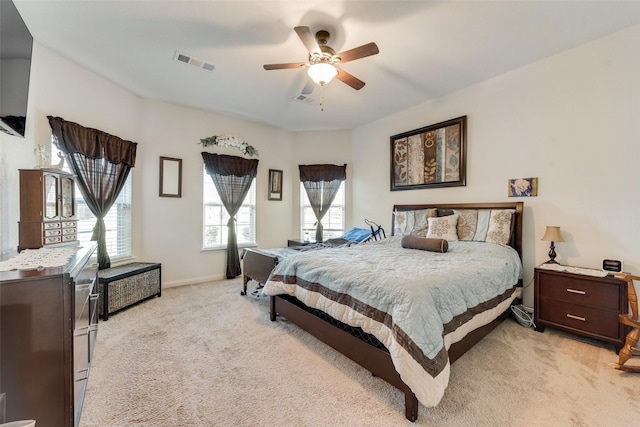 bedroom with ceiling fan and light carpet