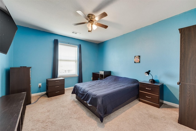 bedroom with ceiling fan and light colored carpet