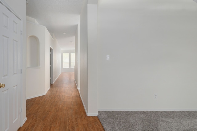 corridor with wood-type flooring