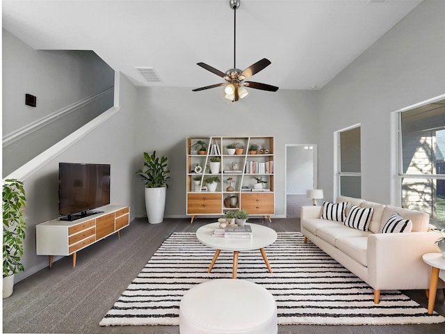 carpeted living room featuring ceiling fan