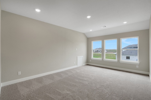 unfurnished room featuring recessed lighting, baseboards, light carpet, and vaulted ceiling