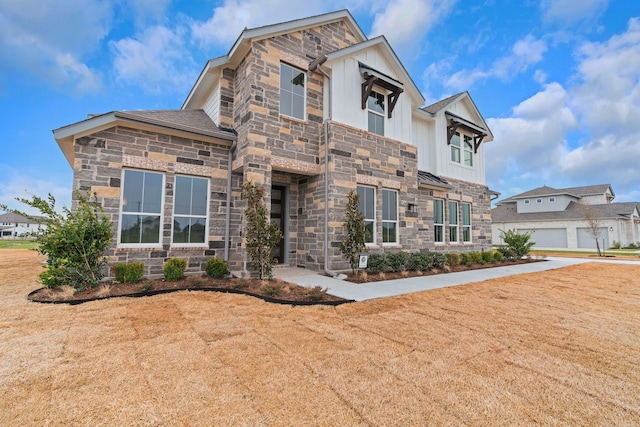 view of front of house with stone siding and board and batten siding