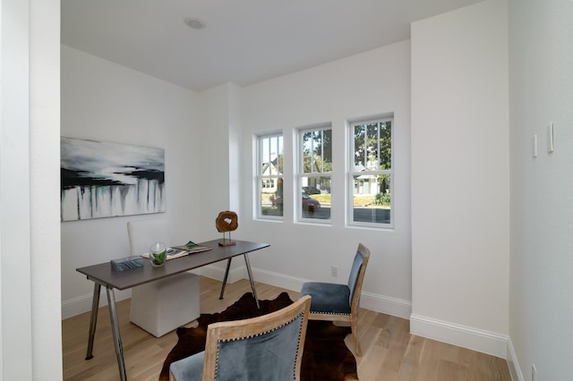 home office with light hardwood / wood-style flooring