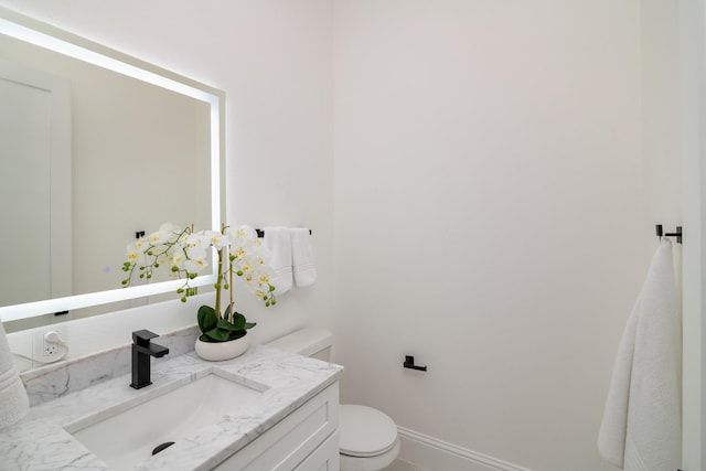 bathroom featuring toilet and vanity