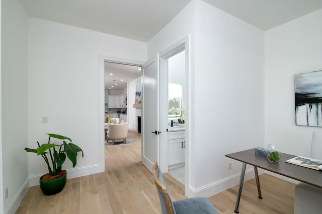 hallway with light hardwood / wood-style flooring