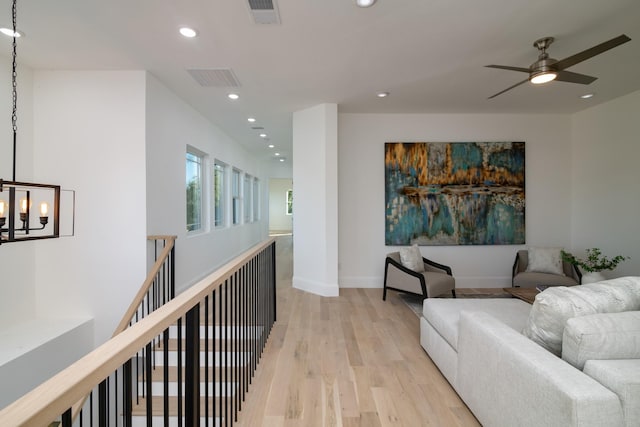 interior space with ceiling fan and light hardwood / wood-style flooring