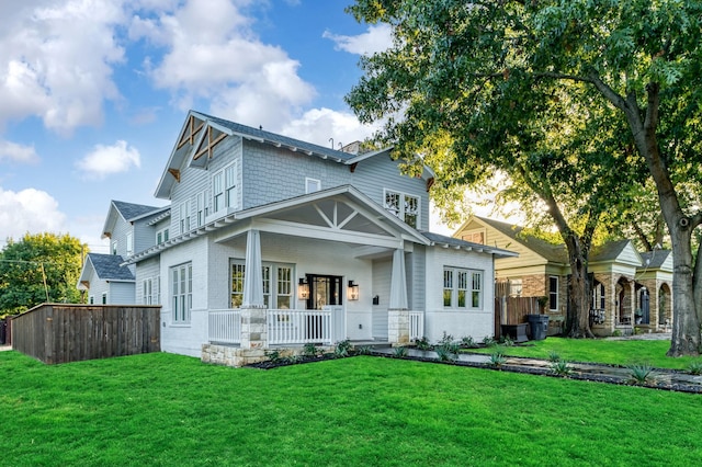 view of front of property with covered porch and a front yard