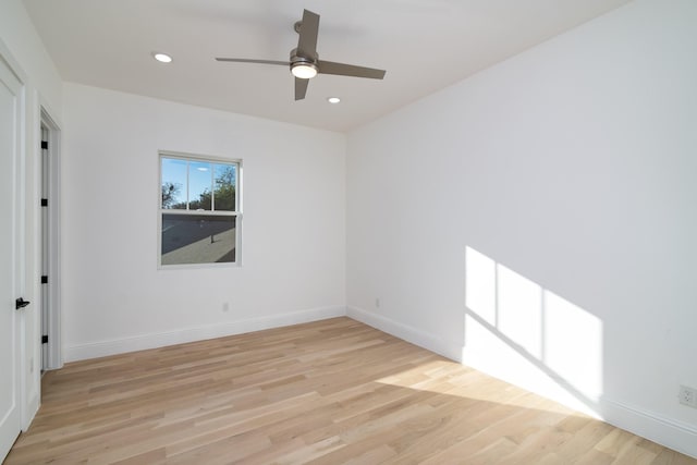 empty room with light wood-type flooring and ceiling fan