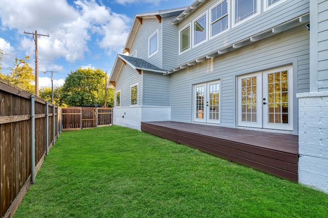 view of yard featuring a deck and french doors