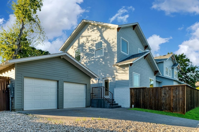 view of side of home with a garage and an outdoor structure