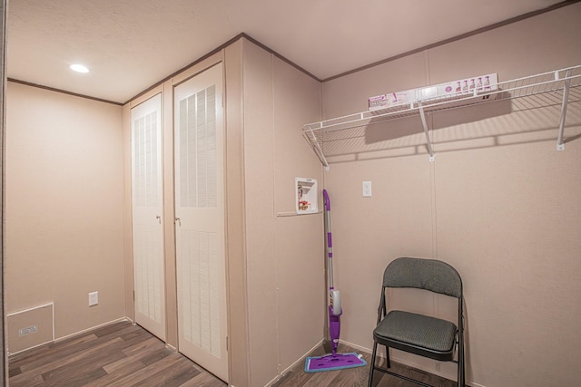 laundry room with wood-type flooring