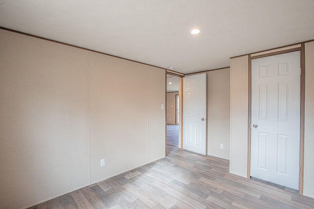 unfurnished bedroom with light wood-type flooring