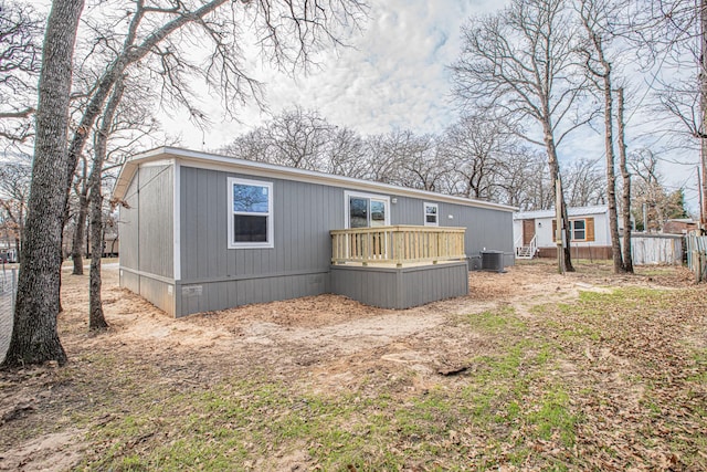 back of property featuring central air condition unit and a wooden deck