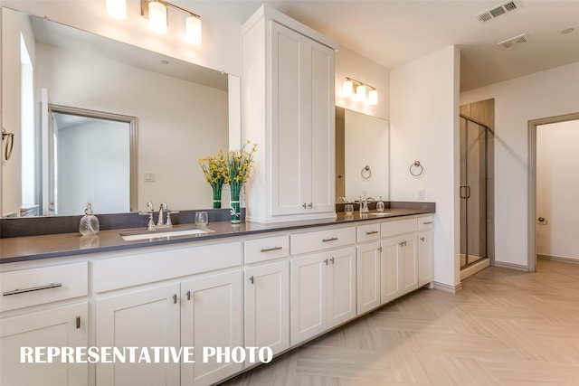 bathroom featuring vanity, walk in shower, and parquet flooring