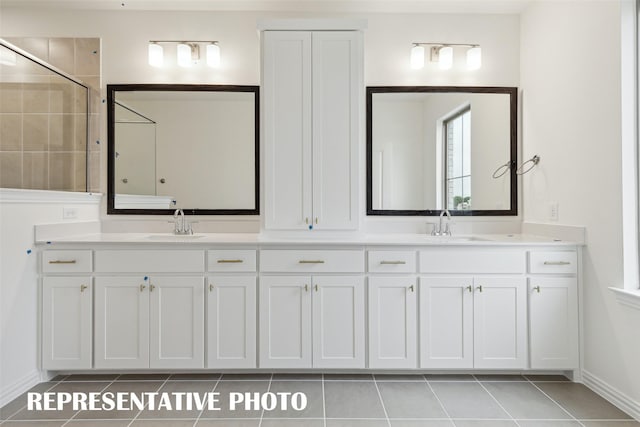 bathroom featuring vanity, tile patterned floors, and tiled shower