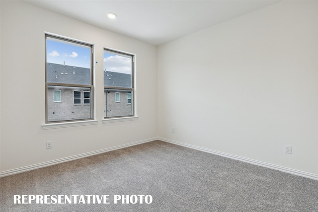 unfurnished room with carpet flooring