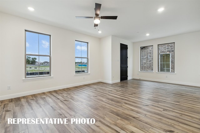 unfurnished room featuring light wood-type flooring and ceiling fan