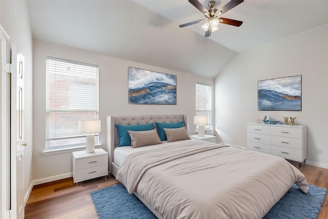 bedroom featuring vaulted ceiling, ceiling fan, and wood-type flooring