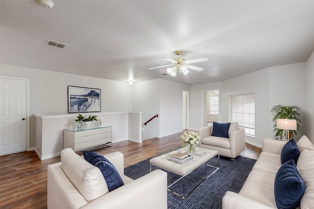 living room with dark wood-type flooring and ceiling fan