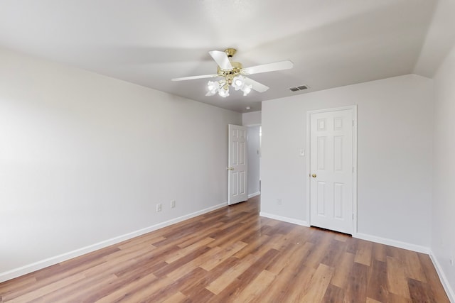 unfurnished bedroom with ceiling fan and wood-type flooring