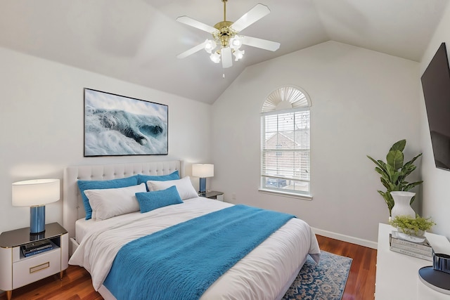 bedroom with ceiling fan, dark wood-type flooring, and lofted ceiling