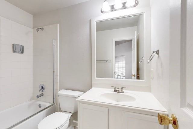 full bathroom featuring toilet, tiled shower / bath combo, and vanity