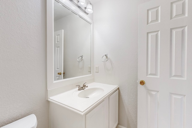 bathroom with toilet and vanity