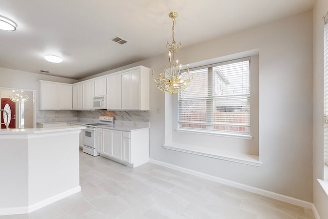 kitchen featuring decorative light fixtures, decorative backsplash, white appliances, white cabinets, and a chandelier