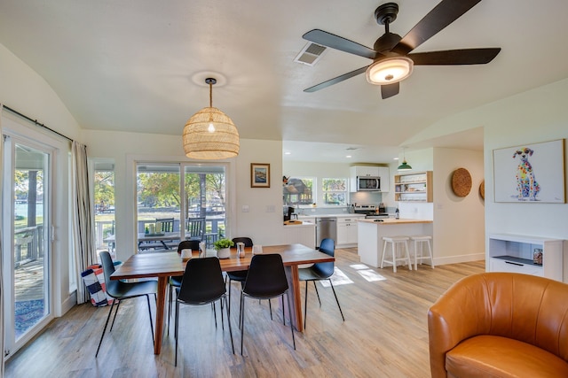 dining space with lofted ceiling, light wood-type flooring, and ceiling fan