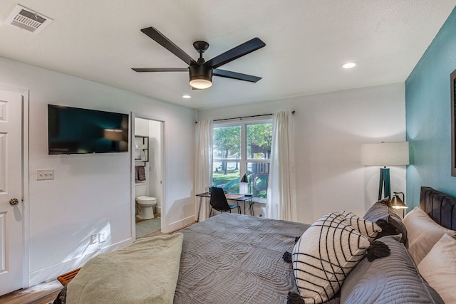 bedroom with ceiling fan, connected bathroom, and hardwood / wood-style flooring