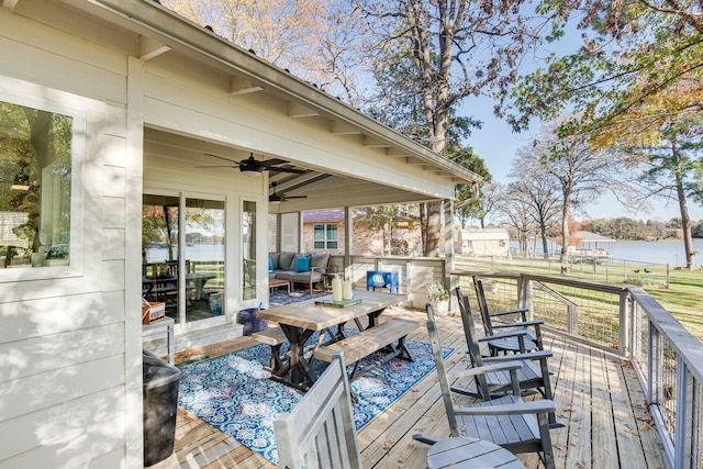 wooden terrace featuring ceiling fan and a water view