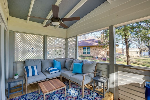 sunroom / solarium featuring lofted ceiling and ceiling fan