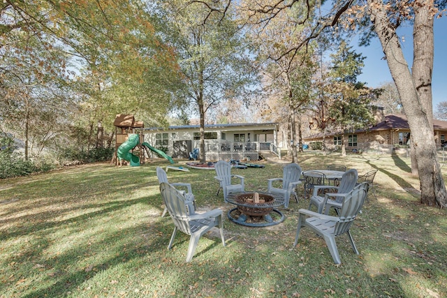 view of yard featuring a fire pit and a playground