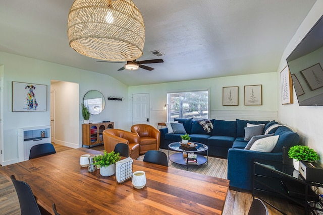 dining space featuring lofted ceiling, ceiling fan, and hardwood / wood-style floors