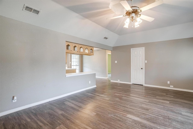 spare room with ceiling fan, dark wood-type flooring, and vaulted ceiling