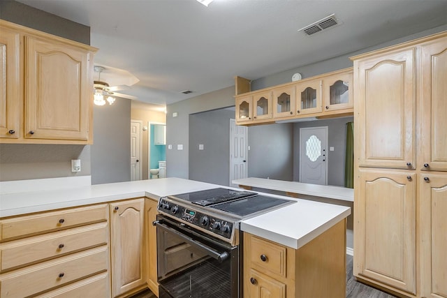 kitchen featuring light brown cabinetry, ceiling fan, black range with electric cooktop, and kitchen peninsula