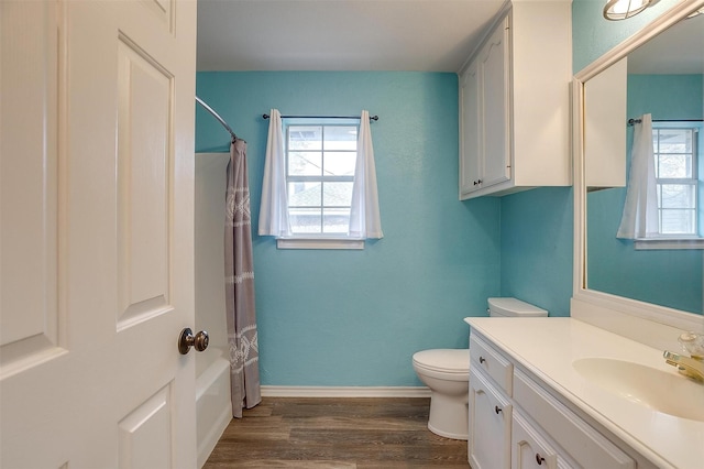 full bathroom featuring toilet, wood-type flooring, vanity, and shower / bath combination with curtain