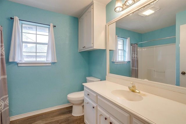 bathroom featuring toilet, curtained shower, vanity, and hardwood / wood-style floors