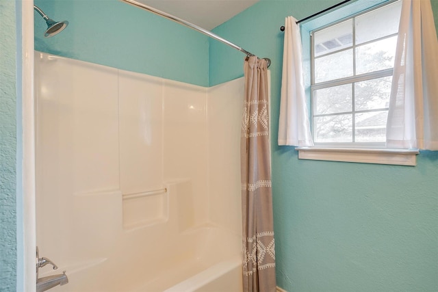 bathroom with shower / tub combo