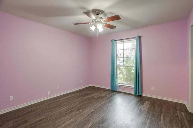 spare room with ceiling fan and dark wood-type flooring