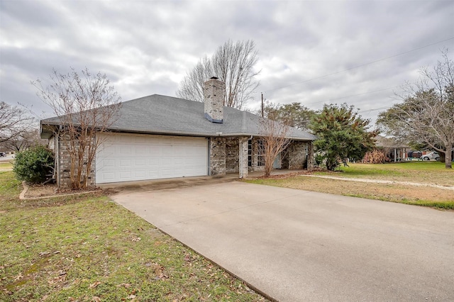 ranch-style home with a garage and a front lawn