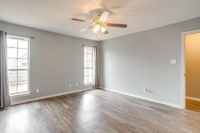 empty room featuring ceiling fan and light hardwood / wood-style floors