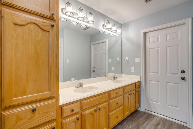 bathroom featuring vanity and hardwood / wood-style flooring